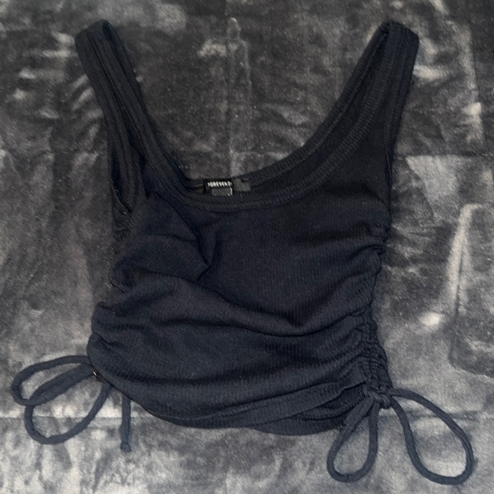selling cute, cropped, black tank top. From forever21 and it’s a size (S)